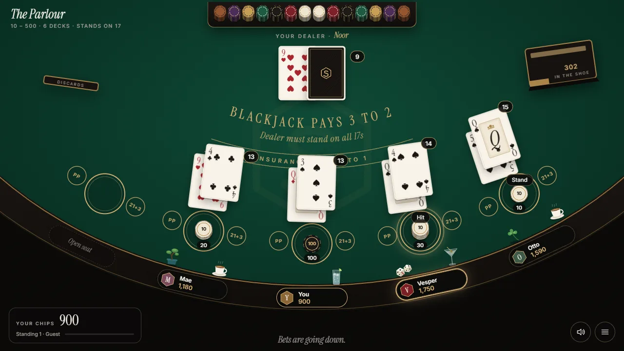A hand in the Parlour, with cards dealt around the green table under Blackjack pays 3 to 2.